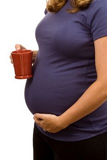 Pregnant woman with coffee