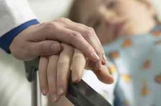 Doctor holding patient's hand